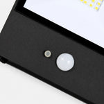 Cargar imagen en el visor de la Galería, Close view of motion sensor and glass diffuser on black outdoor wall lamp