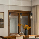 Bild in Gallery-Viewer laden, Three black mesh stone pendant lights above a dining counter
