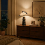 Load image into Gallery viewer, Botanical shade ceramic table lamp on a bedroom cabinet at night