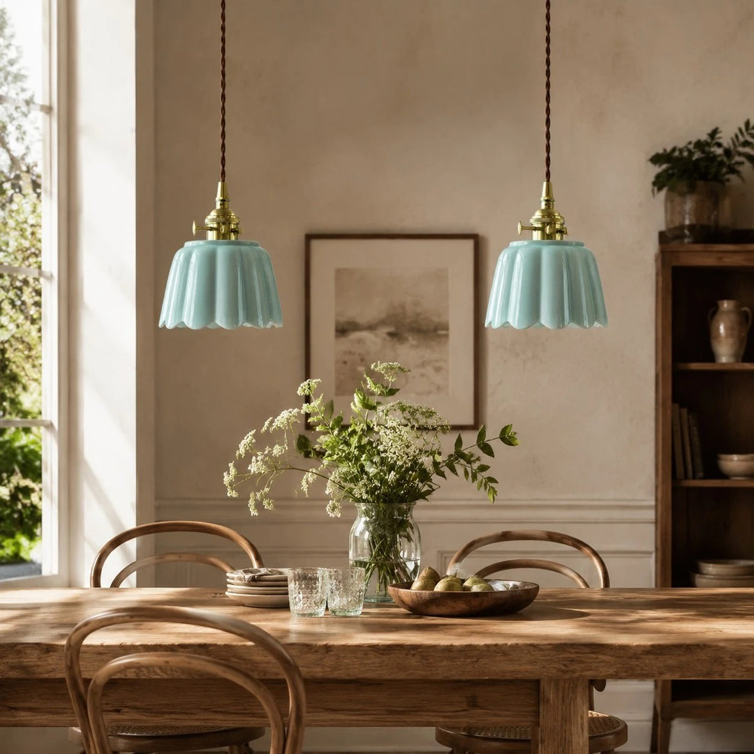 Pair of ceramic lotus pendant lights over a dining table