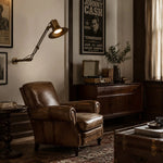 Cargar imagen en el visor de la Galería, Antique Brass folding wall lamp in a warm reading room