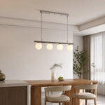 Load image into Gallery viewer, White globe chandelier in a bright dining room