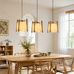 Cargar imagen en el visor de la Galería, Three wood frame fabric pendant lights over a dining table