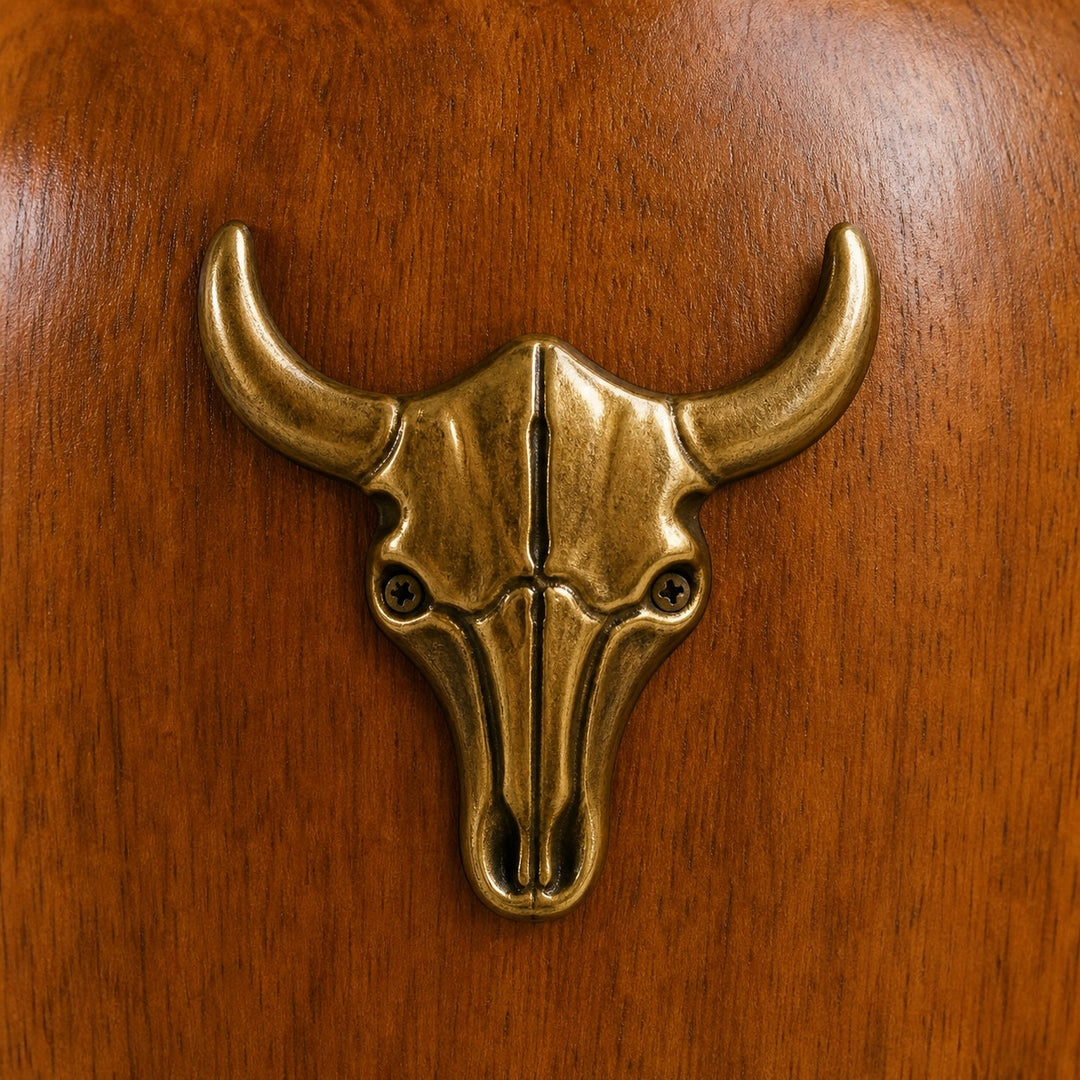 Brass bull-head accent on the wood lamp body