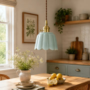 Ceramic lotus pendant installed over a kitchen table