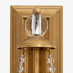 Load image into Gallery viewer, Close view of carved brass backplate and crystal ornament