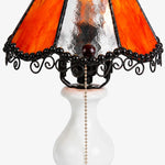 Load image into Gallery viewer, Close view of amber stained glass shade, black lace trim and decorative lamp frame