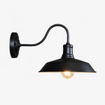 Charger l'image dans la visionneuse de galerie, Black wall sconce with warm light on white background