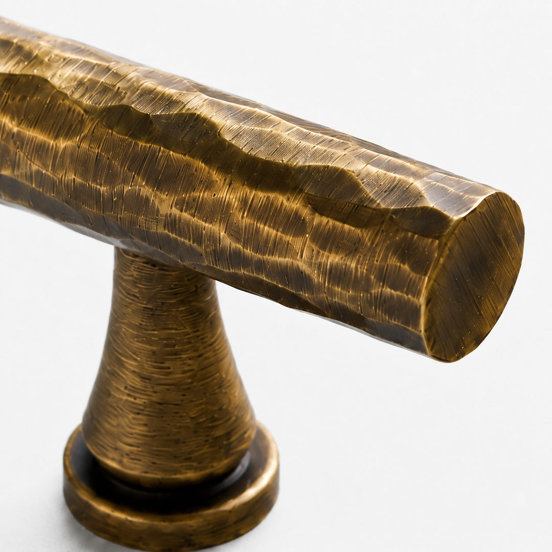 Close view of the Antique Brass T-Bar knob edge and mounting stem