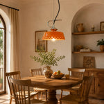 Load image into Gallery viewer, Orange metal and ceramic pendant lamp in a warm kitchen dining nook