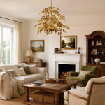 Cargar imagen en el visor de la Galería, Gold tiered palm leaf chandelier in a country living room