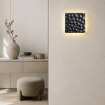Load image into Gallery viewer, Pair of carved travertine wall sconces installed on a modern wall