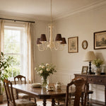 Bild in Gallery-Viewer laden, Cream and brown chandelier hanging above a rectangular dining table