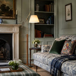 Cargar imagen en el visor de la Galería, White fabric floor lamp beside a patterned sofa