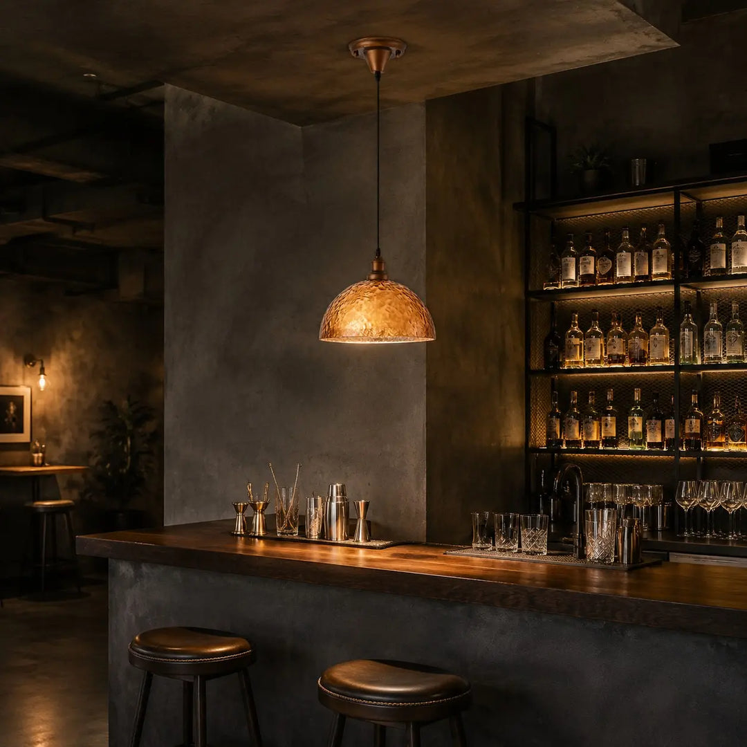 Amber pendant light above a home bar
