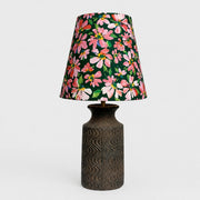 Front view of floral fabric table lamp with textured dark ceramic base