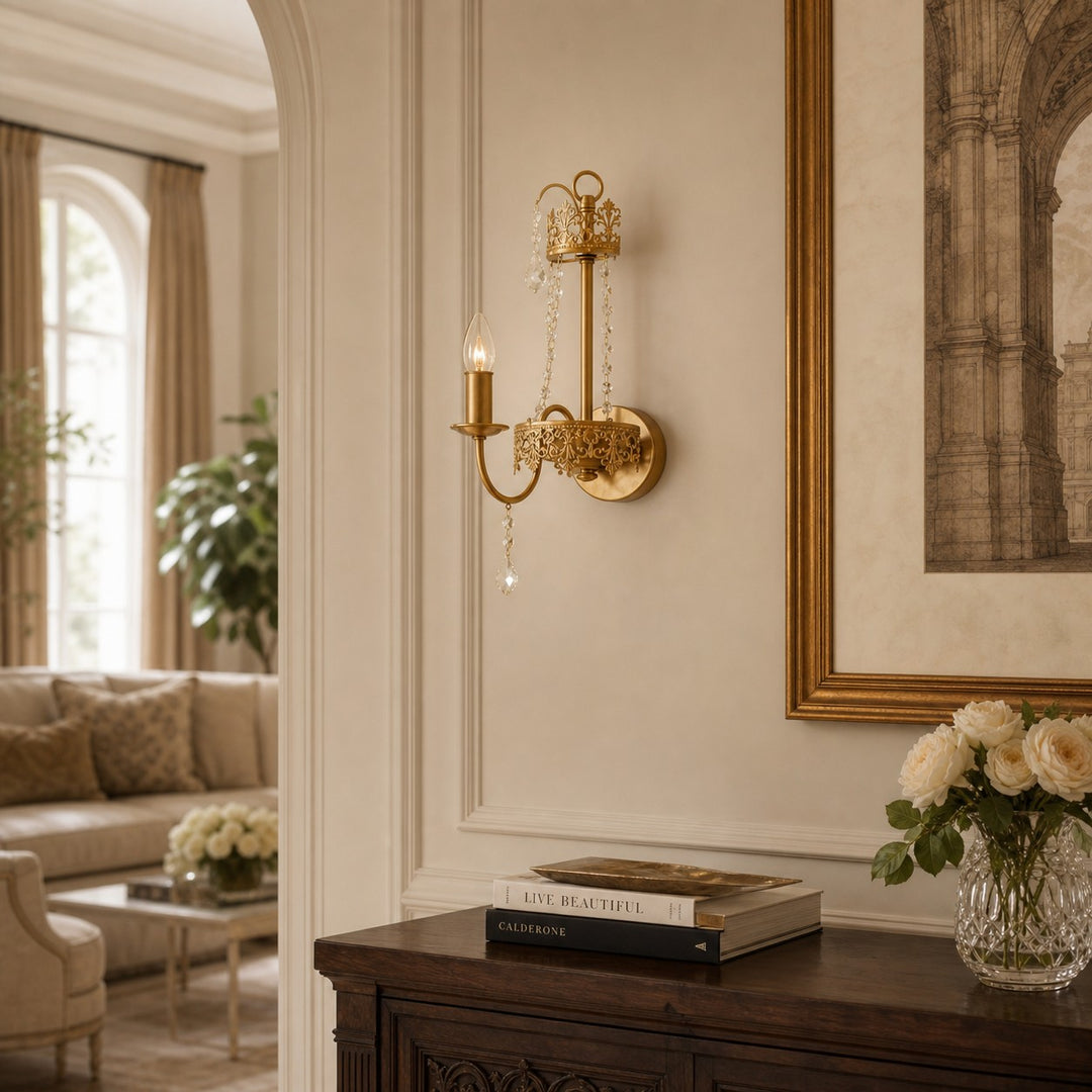 Antique brass crystal wall sconce illuminating an elegant interior passage