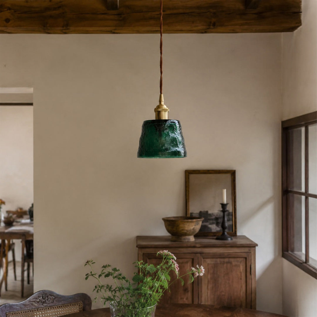 Green glass pendant light in a warm home setting
