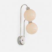 Close view of polished metal arm and milk coffee glass shade