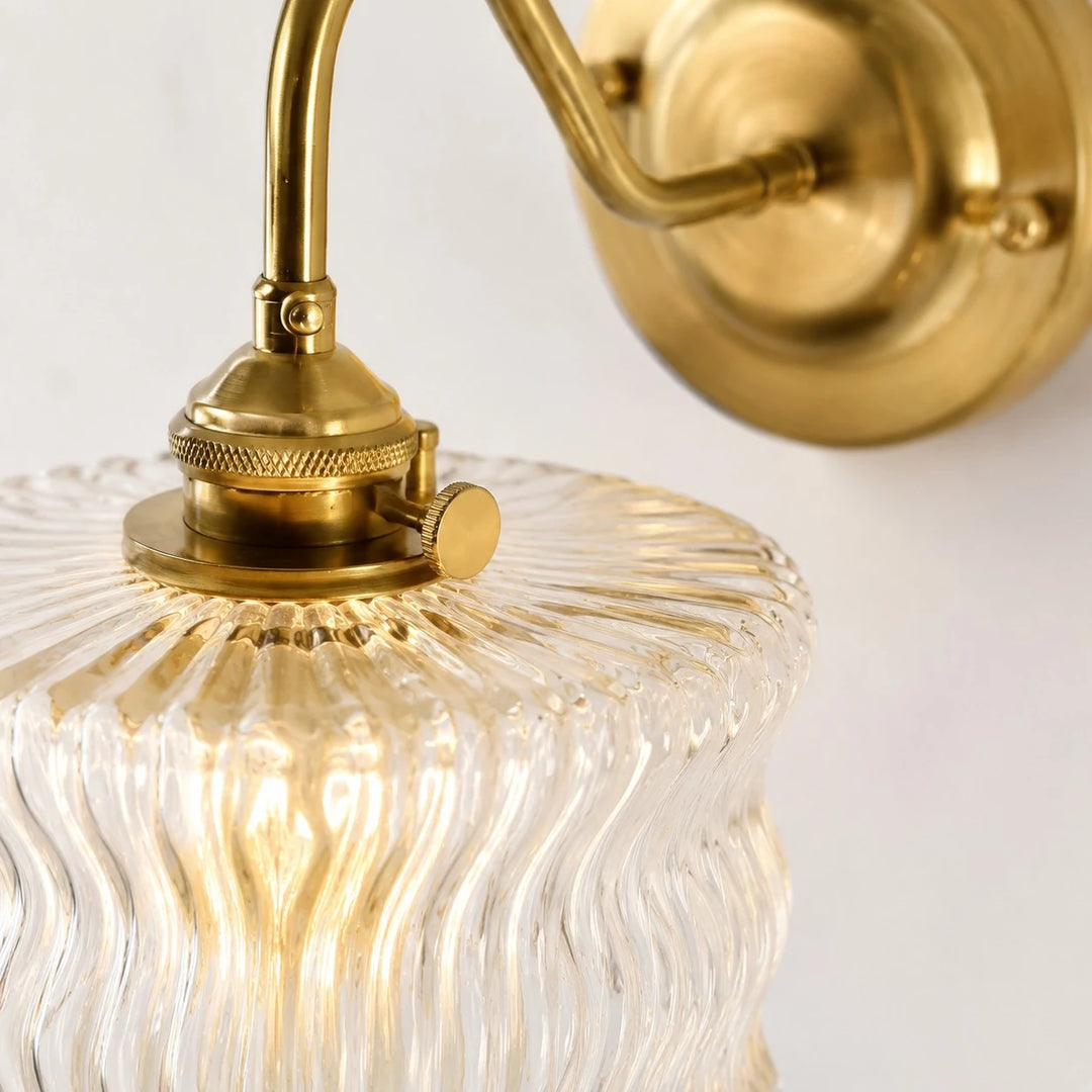 Close detail of clear ripple glass shade and brass fitter