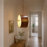 Bild in Gallery-Viewer laden, Hand-laced leather cylinder pendant light in an interior setting