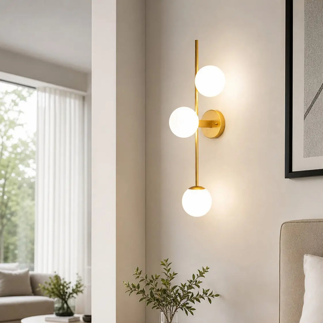 Three-light glass wall sconce in a styled interior