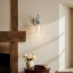 Cargar imagen en el visor de la Galería, Chrome ribbed glass wall sconce adding soft light to a plaster wall