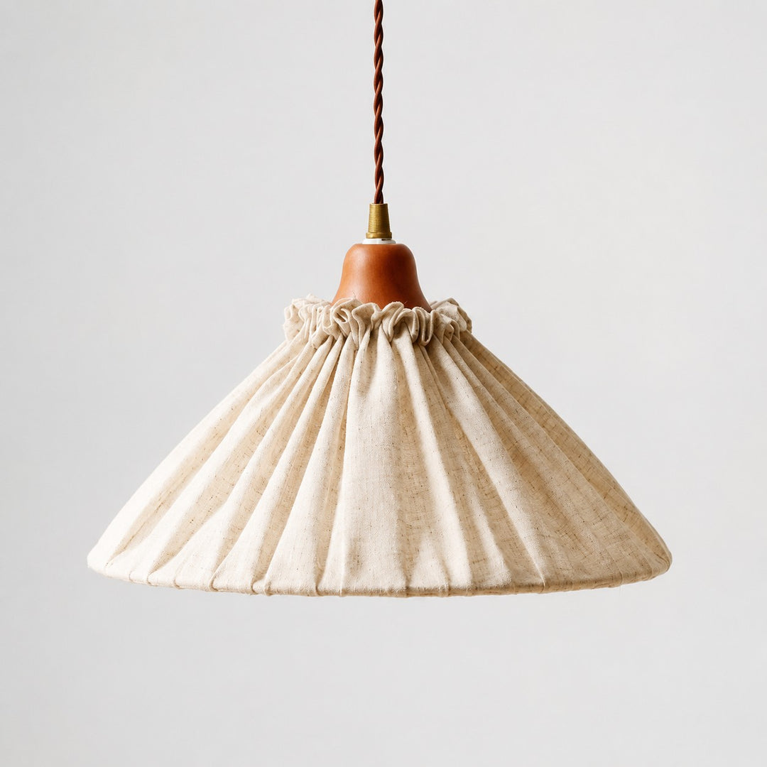 Front view of natural linen pleated pendant light with wood socket cover and twisted cord
