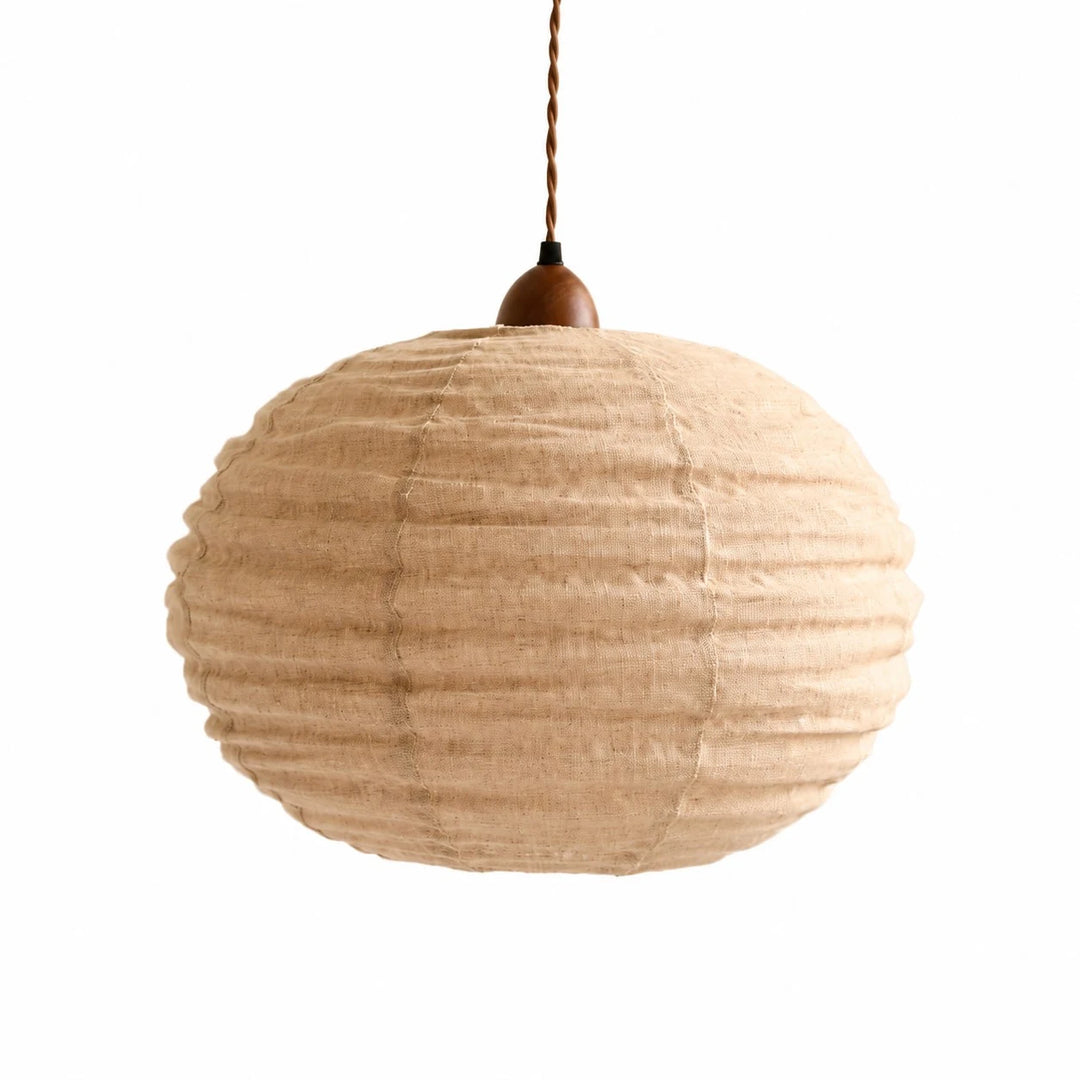 Apricot cotton-linen round pendant light on a white background