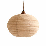 Apricot cotton-linen round pendant light on a white background