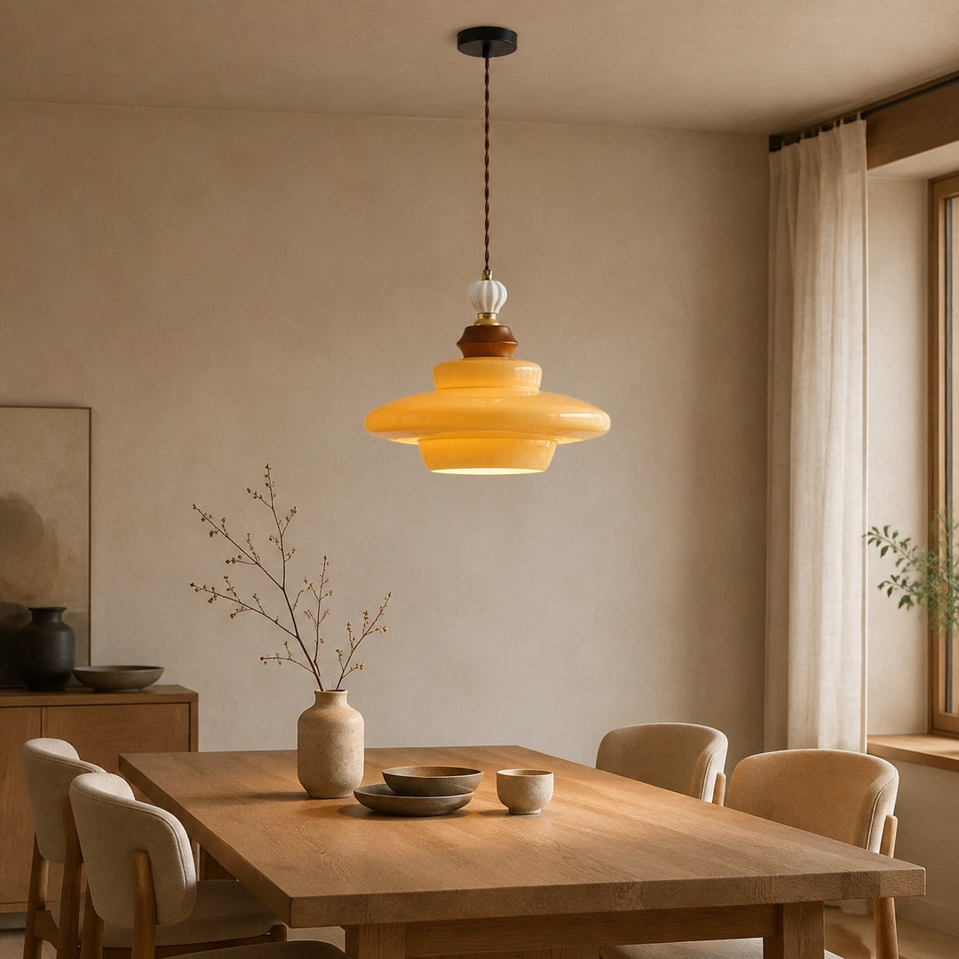 Caramel yellow glass pendant light above a dining table