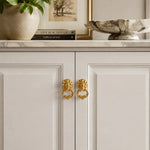 Cargar imagen en el visor de la Galería, Brass ring pulls on white cabinet doors