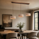 Load image into Gallery viewer, Three-light yellow travertine pendant installed above a long dining table
