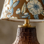 Cargar imagen en el visor de la Galería, Close view of blue floral fabric lampshade and ceramic neck