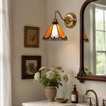 Load image into Gallery viewer, Orange stained glass wall sconce in a bedside nook