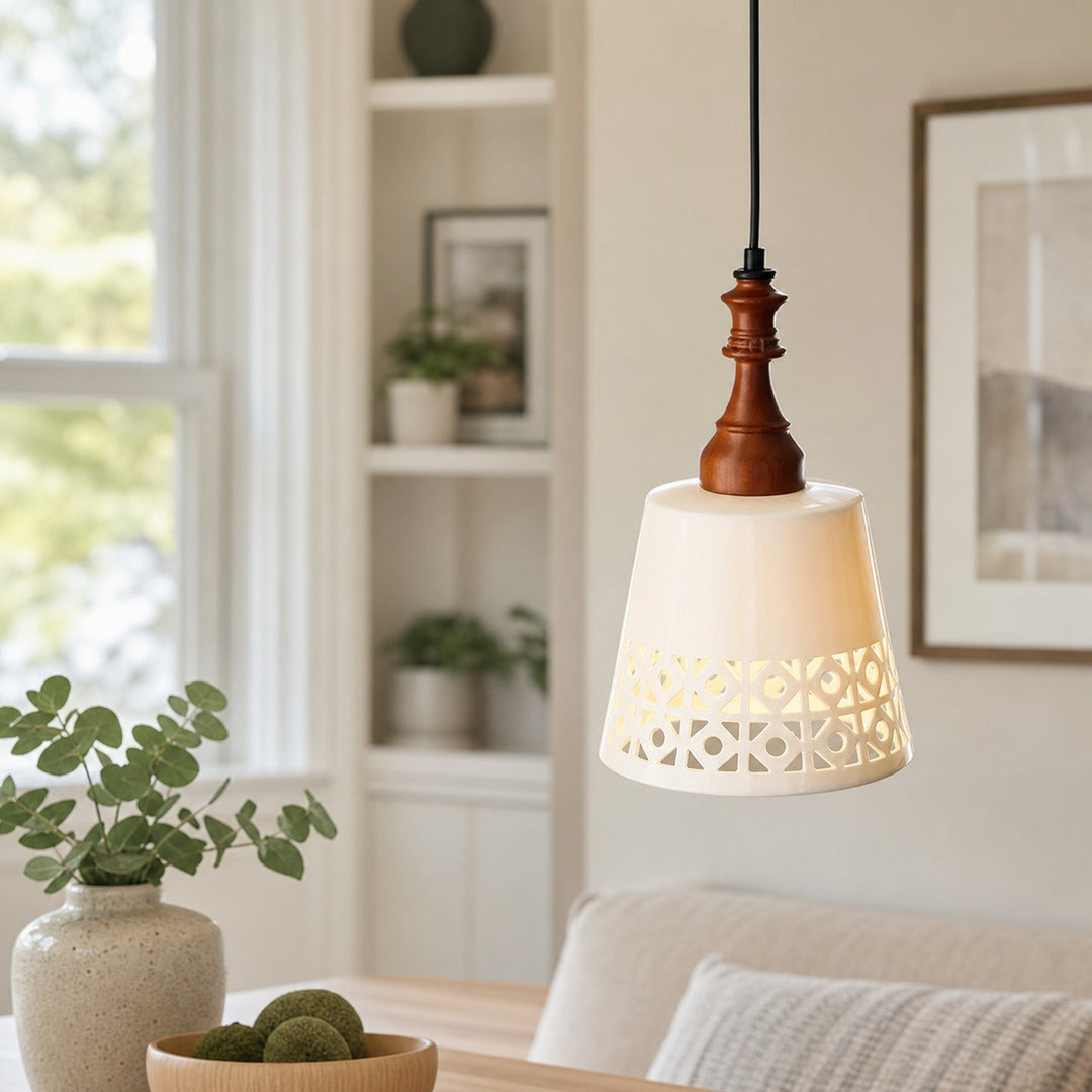 cream ceramic cutout pendant light beside a window