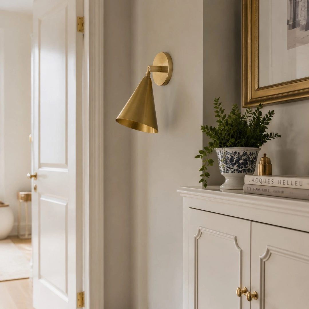 Natural brass wall light in a soft hallway setting