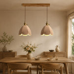 Load image into Gallery viewer, Two natural leather pendant lights above a dining table