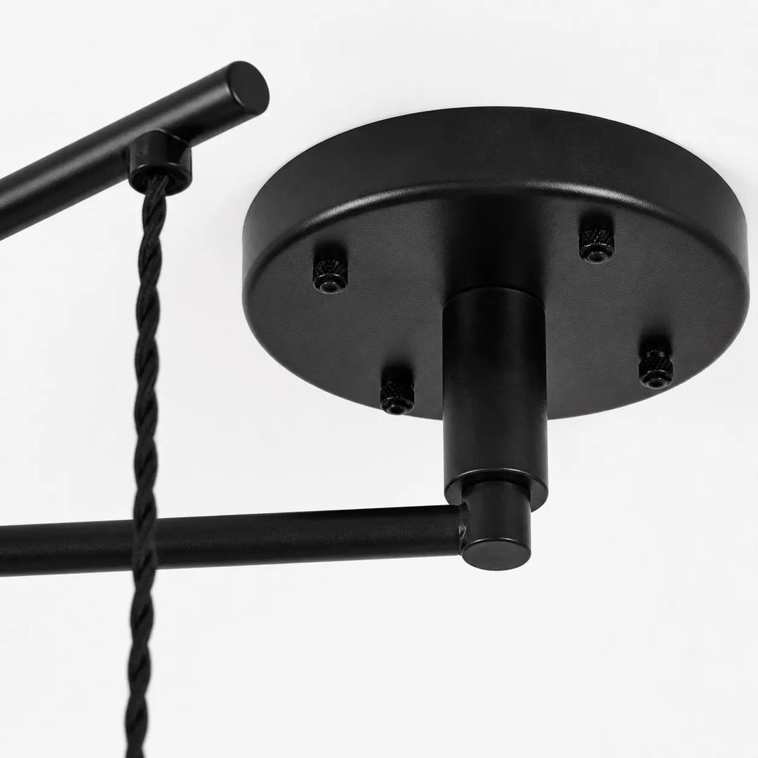 Black ceiling canopy and movable arm connection detail