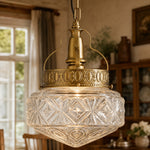 Cargar imagen en el visor de la Galería, Clear glass pendant light glowing in a warm dining room