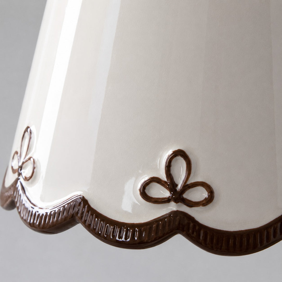 hand-painted brown floral edge on the white ceramic shade