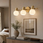 Load image into Gallery viewer, Three-light gold wall sconce in a refined hallway