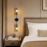 Cargar imagen en el visor de la Galería, Black copper two-head alabaster wall sconce installed beside a bed