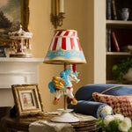 Bild in Gallery-Viewer laden, Circus carousel unicorn table lamp in a warm vintage room