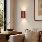 Load image into Gallery viewer, Brown leather wall sconce installed in a warm living room