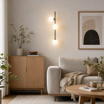Load image into Gallery viewer, Three-light wall sconce installed in a refined interior