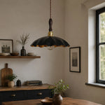 Load image into Gallery viewer, black cowhide pendant light over a warm dining table near a window