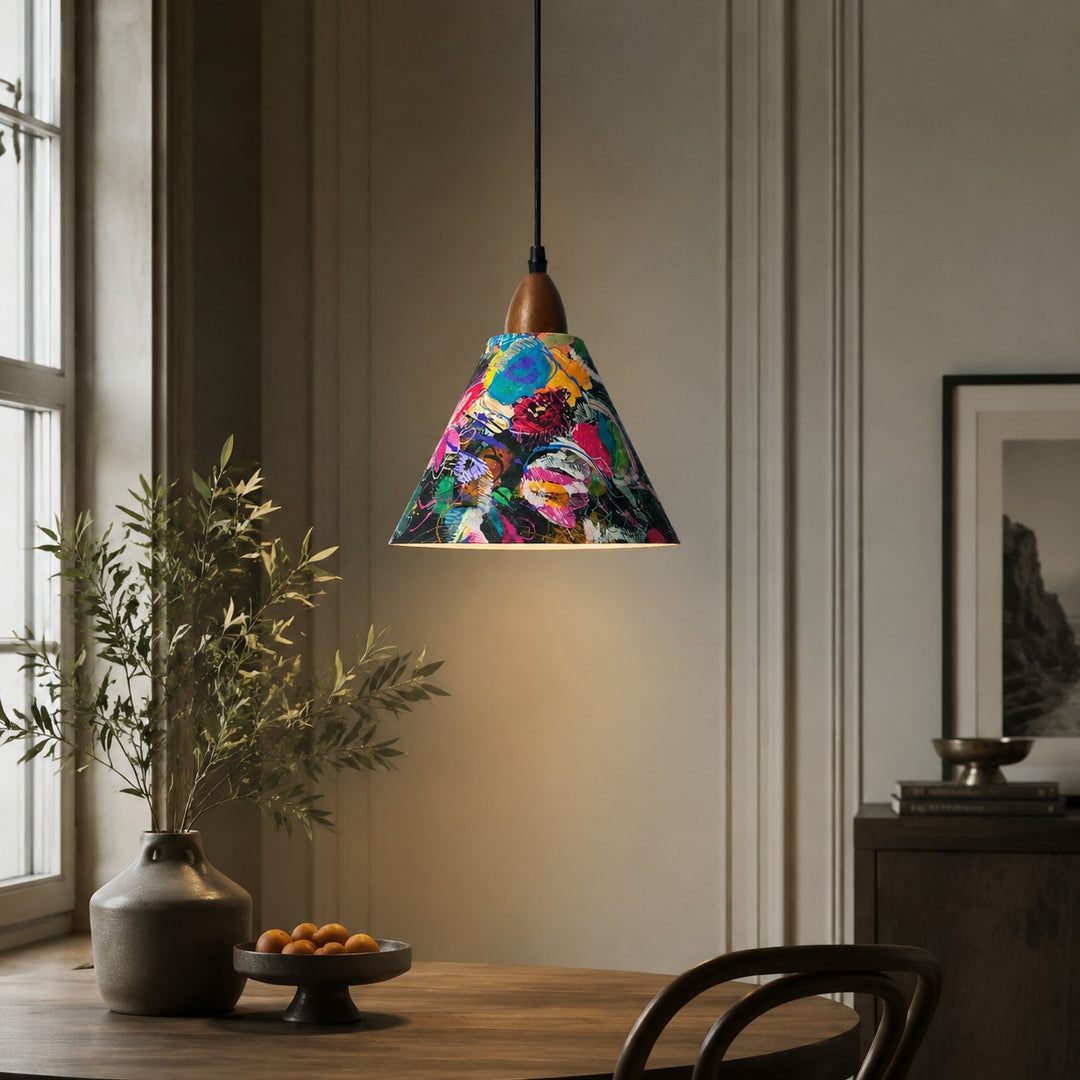 Painted floral pendant above wood table in softly shadowed dining room