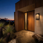 Cargar imagen en el visor de la Galería, Outdoor wall light mounted beside a garden wall