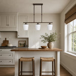Load image into Gallery viewer, Strellux three-head Coffee Brown chandelier over a compact kitchen bar